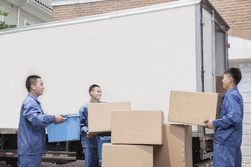 Movers carrying furniture during a Barkingside relocation