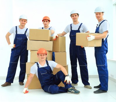 Packed moving boxes and furniture ready for collection in Barkingside home